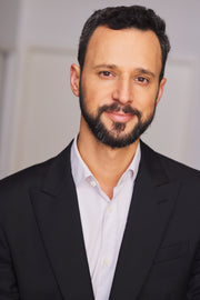 A man in a suit with a close-up focus on his face and neck, showcasing professional attire.